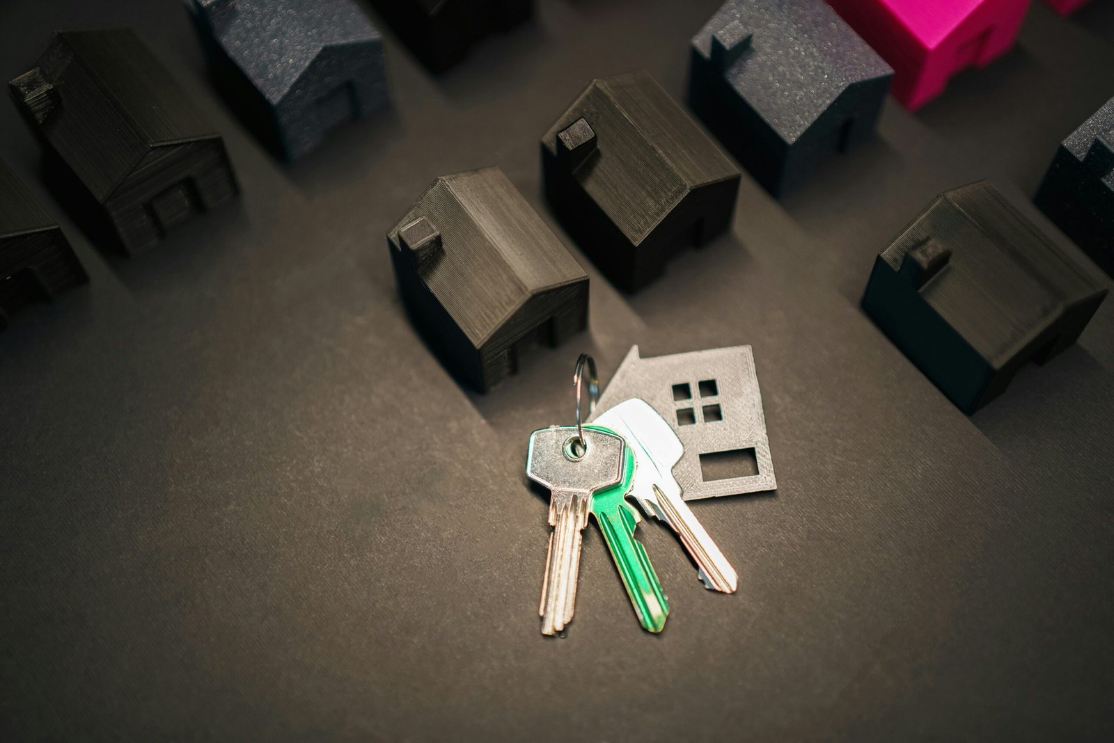 Keys representing a new home and many house models.